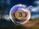 Picture of three bitcoins inside a bubble